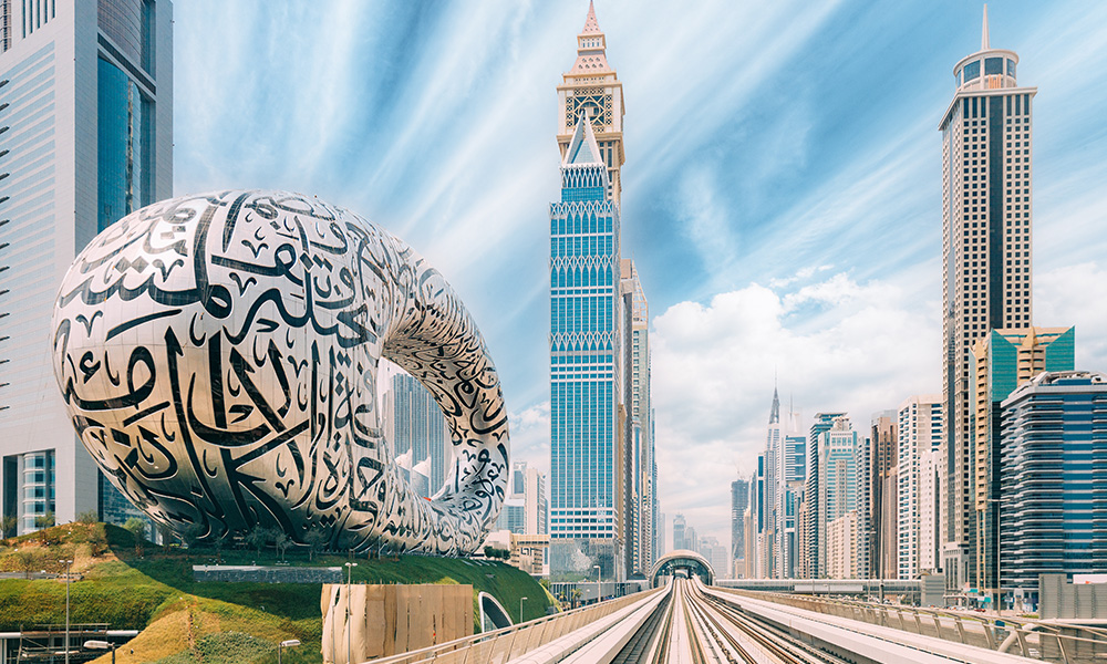 Metro railway among among glass skyscrapers in Dubai. Traffic on street in Dubai. Museum of the Future in Dubai. Cityscape skyline. Urban background.